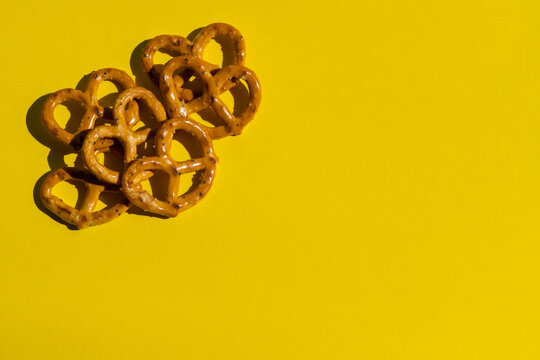 Salt pretzels on the yellow background, traditional beer snack