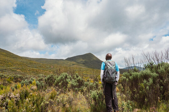 Rear view of a hiker against a mountain background at Mount Kenya, Kenya