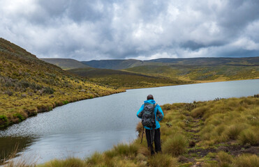 Rear view of a hiker at Lake Ellis, Chogoria Route in Mount Kenya National Park, Kenya