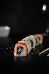 Sushi on a plate. Black background.