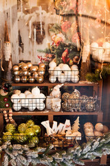 Christmas balls and decorations on shelves at shop.
