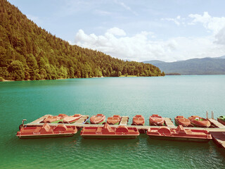 Pier with rental row boats and yachts at mountain lake Walchensee