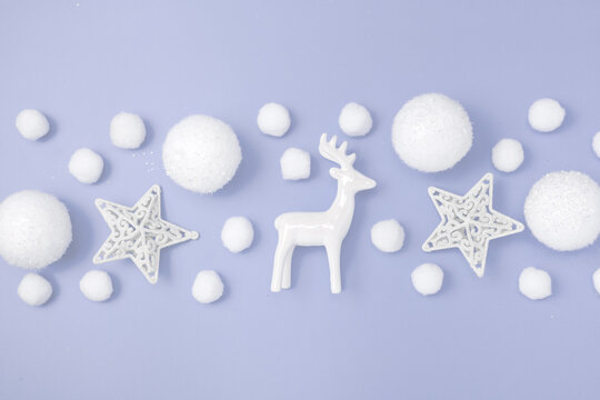 Christmas pattern border. Deer, balls, white stars on a purple pastel background