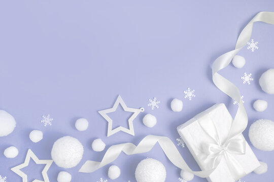 Christmas composition. White balls, snowflakes, gifts on purple pastel background
