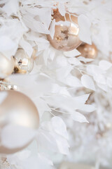 Fototapeta na wymiar Christmas composition. Garland made of baige balls and white flowerss on white background. Christmas, winter, new year concept. Flat lay, top view, copy space