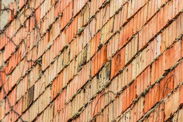 Brick wall of an old building shot in perspective. Demolition or restoration concept