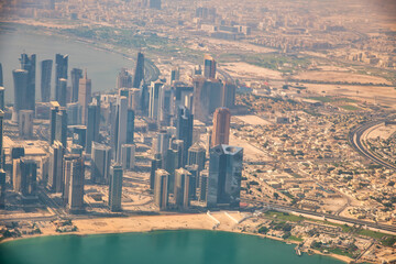 Naklejka premium Doha, Qatar - September 17, 2018: Aerial view of city skyline from a flying airplane over the Qatar capital