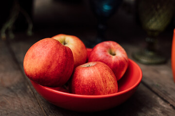 A plate of red apples on the table. Autumn composition.
