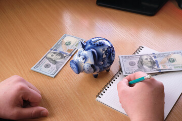 business finance saving and investment concept. Piggy Bank, Savings, Currency. ceramic piggy bank standing on dollars. saving money..