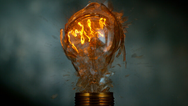 Freeze motion of light bulb exploding, dark background