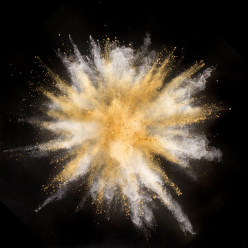Freeze motion shot of color powder explosion isolated on black background
