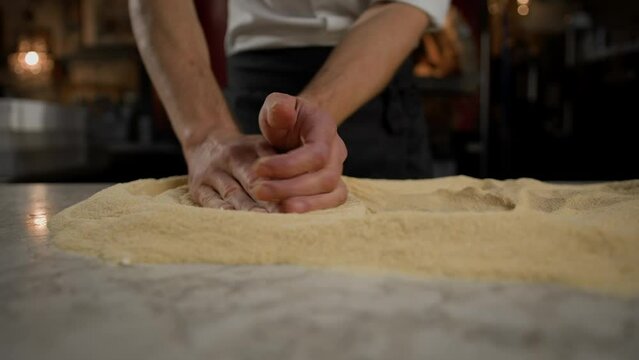 In Restaurant Professional Chef Preparing Pizza, Kneading Dough, flouring it. Authentic Sunny Pizzeria, Cooking Delicious Organic Food. Slow Motion Cinematic