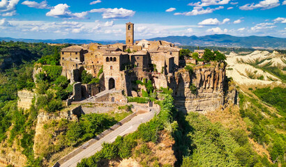 Amazing aerial view of Civita di Bagnoregio landscape in summer season, Italy. This is a famous medieval italian town - obrazy, fototapety, plakaty