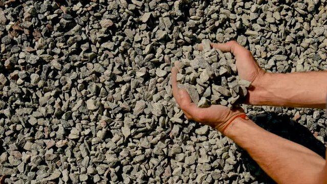 A man holds a rubble in his hands. Selective focus.