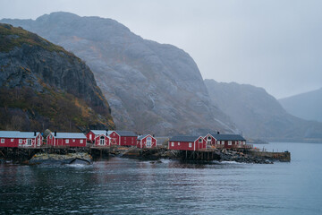 Nusfjord fishing village views inside Lofoten Islands. Colorful wooden rorbu, a fisherman’s cabins, with distinctive bright red paint and white trim