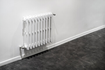 white radiator on a light wall in the room