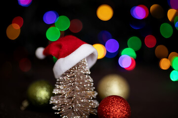 Fototapeta na wymiar Christmas tree and Santa hat. Christmas background. Christmas light. Garland Light