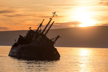 Fototapeta premium Abandoned ships on the beach of Severo-Kurilsk. Russia