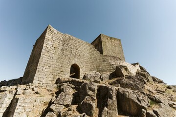 Low-angle shot of a building made of bricks in the Castle of Marialva, Portugal