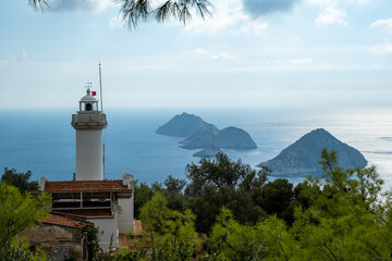 Lighthouse on the hill with islands on a background