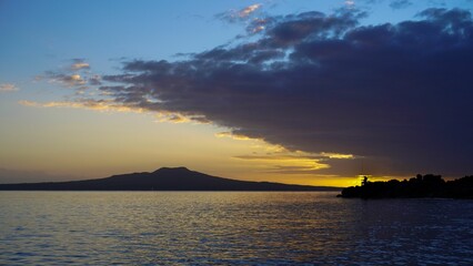 Scenic view of a sunset over the lake and silhouettes of hills