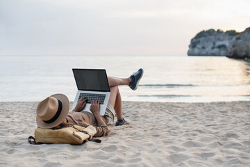 Young woman using laptop computer on beach, freelancer girl working remote, Freelance work, online...