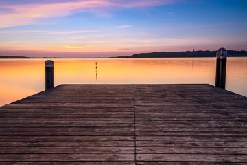 Obraz na płótnie Canvas Wooden Pier in Harrislee on the Baltic Sea at sunrise
