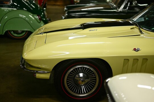 Process of repairing vintage 60s corvette in a classic car garage-museum