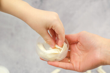 A woman gives Swedish snus to a child, close-up