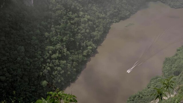 A boat is sailing across the Sumidero Canyon river