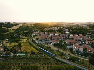 Aerial of a train going next to the town.