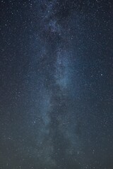 Vertical shot of the beautiful sky full of stars.