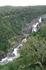 Beautiful view of a waterfall flowing down the rocks in the forest.