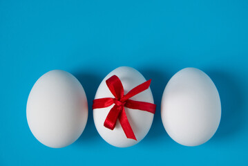 Eggs with a red bow on a blue background