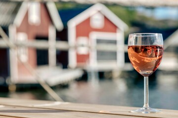 Beautiful shot of a glass of wine in the harbor with blurred background