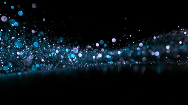Super slow motion of sparkling abstract glittering background in neon colors. Filmed on high speed camera, 1000 fps.