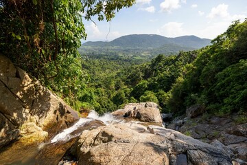 Beautiful view of a forest and mountains from the top of a waterfall