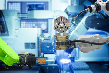 Close-up industrial welding robot working with metal part from gripping robot on smart manufacturing factory, industry 4.0, modern technology with automation robotic arm