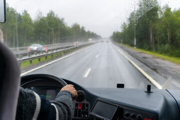 view through the windshield of a tourist bus moving along the highway