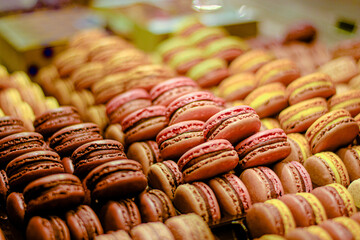 Colorful french macarons being laid on the display