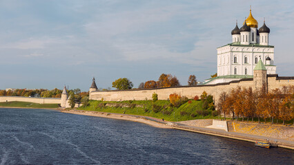 View from the Velikaya River to the Trinity Cathedral of the Pskov Kremlin against the blue autumn...