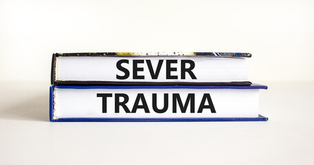Sever trauma symbol. Concept words Sever trauma on books. Beautiful white table white background. Psychological and sever trauma concept. Copy space.