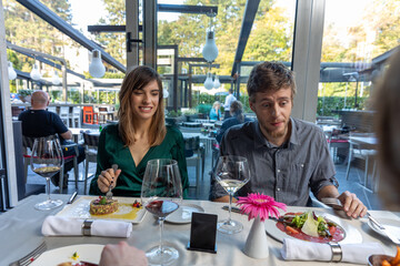 Fototapeta na wymiar Romantic couple having lunch in the restaurant