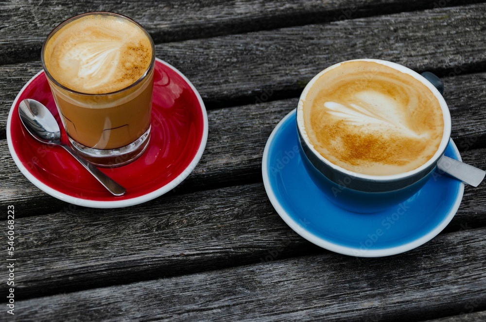 Wall mural top view of two cups of coffee on wooden background