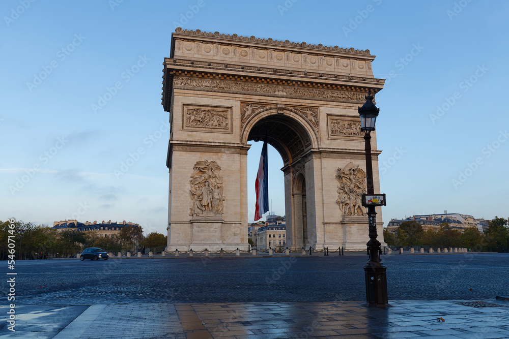 Wall mural the triumphal arch decorated with french flag, paris, france