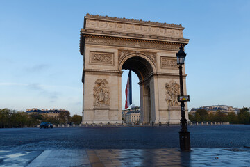 The Triumphal Arch decorated with French flag, Paris, France