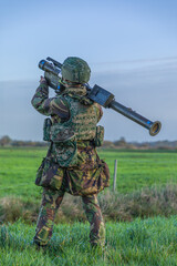 Air defense soldier wit Manpads stinger aiming at a low flying aircraft or helicopter - obrazy, fototapety, plakaty