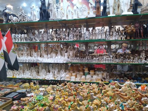 A showcase in a shop with souvenirs, various figurines on the theme of Egypt