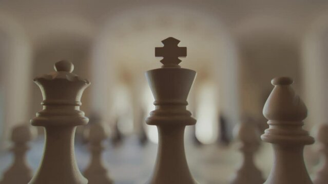 The game of chess. Close-up macro shot of chess pieces on the chessboard. Photorealistic studio shot 3d animation.