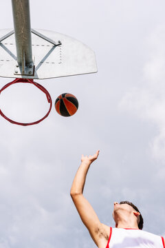 Faceless Man Throwing Ball In Hoop